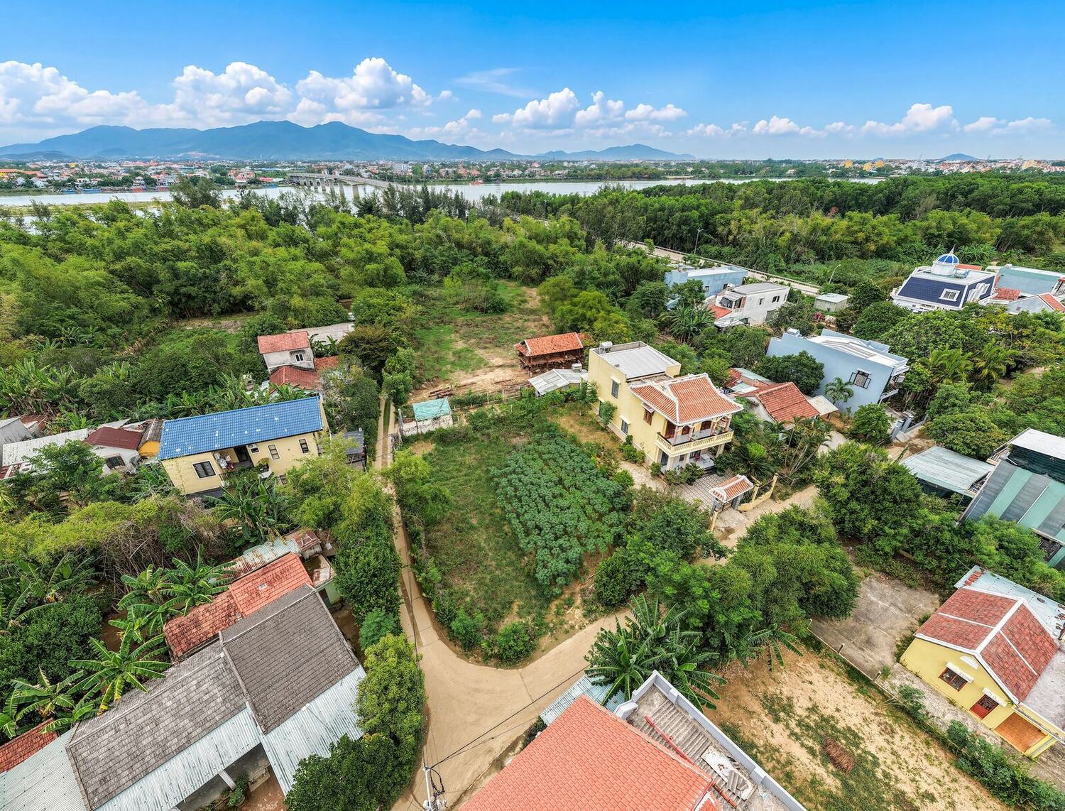 Triêm Tây village and gardens with the mountains beyond